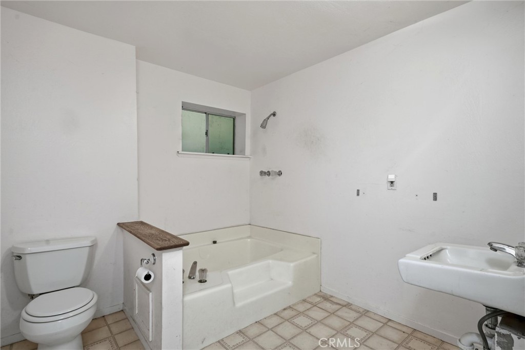 3398 Ogden Road Lucerne, CA 95458 - Photo 19 of 39 a bathroom with a bathtub and toilet