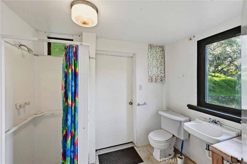 3398 Ogden Road Lucerne, CA 95458 - Photo 28 of 39 a bathroom with a toilet and a shower
