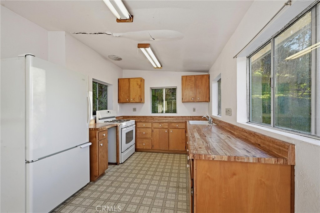 3398 Ogden Road Lucerne, CA 95458 - Photo 10 of 39 a kitchen with a cabinets and white appliances