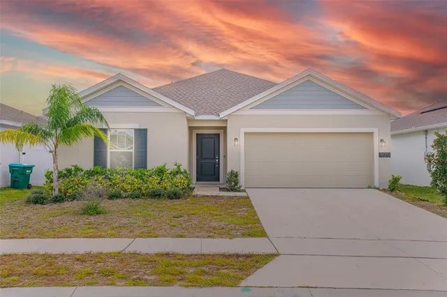 a front view of house with garage and yard