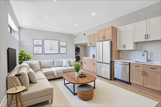 a living room with furniture white refrigerator and couches