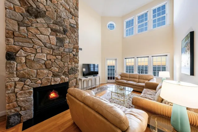 a living room with a couch a fireplace and a flat screen tv