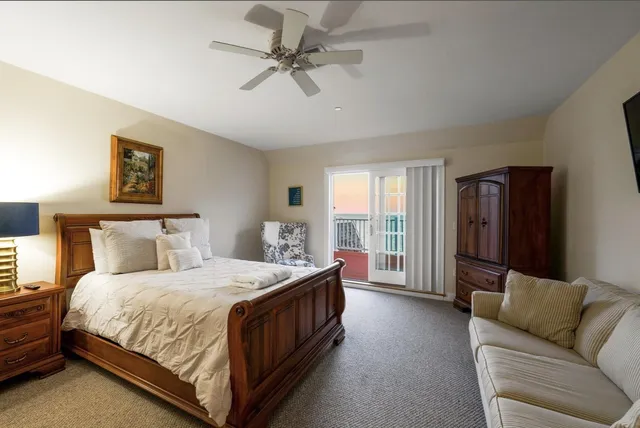 a bedroom with a bed couch and window