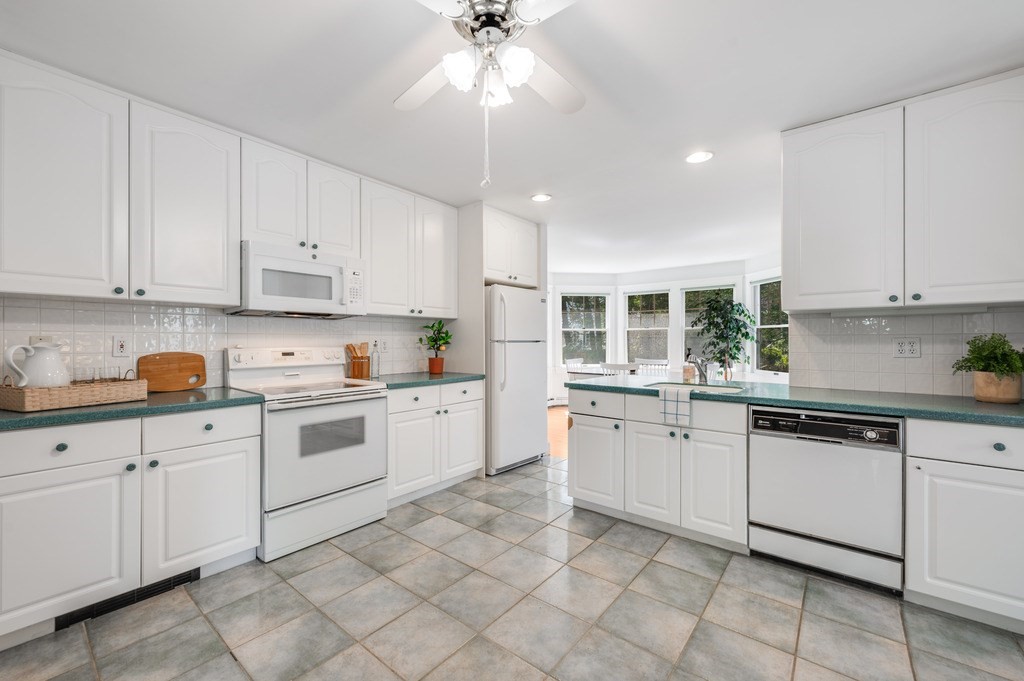 23 Pinewood Road Needham, MA 02492 - Photo 11 of 31 a kitchen with white cabinets white appliances with a sink and dishwasher