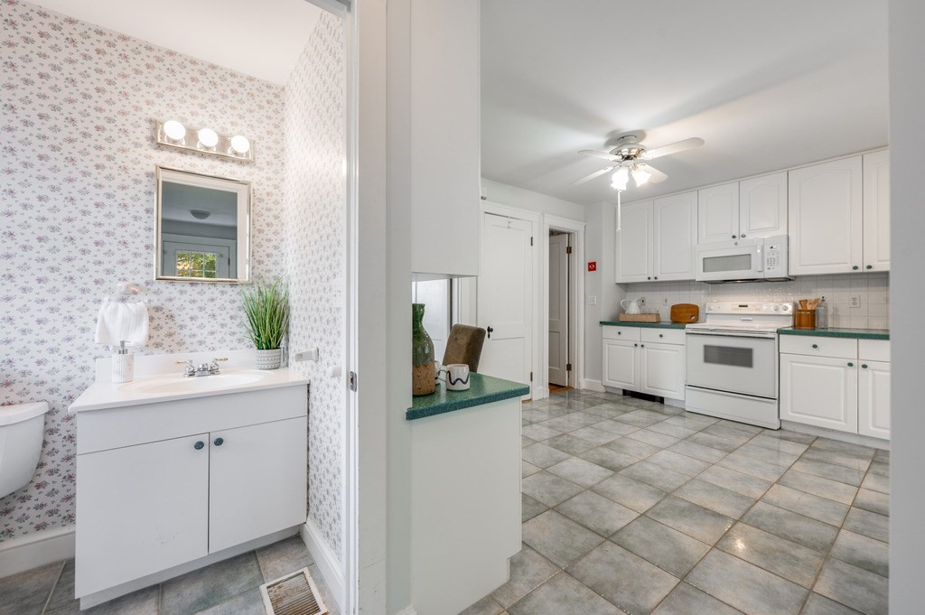 23 Pinewood Road Needham, MA 02492 - Photo 16 of 31 a kitchen with white cabinets and appliances