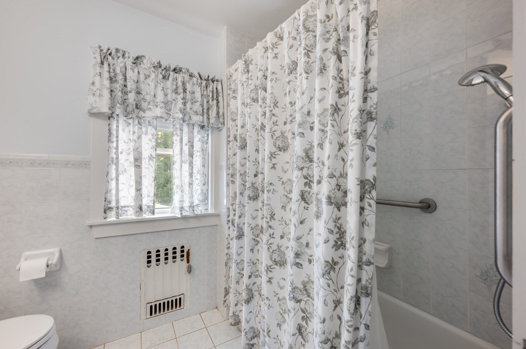 23 Pinewood Road Needham, MA 02492 - Photo 20 of 31 a bathroom with a shower curtain and a toilet