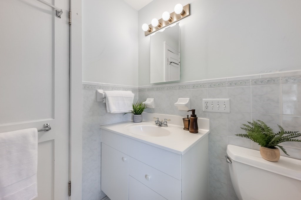 23 Pinewood Road Needham, MA 02492 - Photo 21 of 31 a bathroom with a sink a toilet and mirror