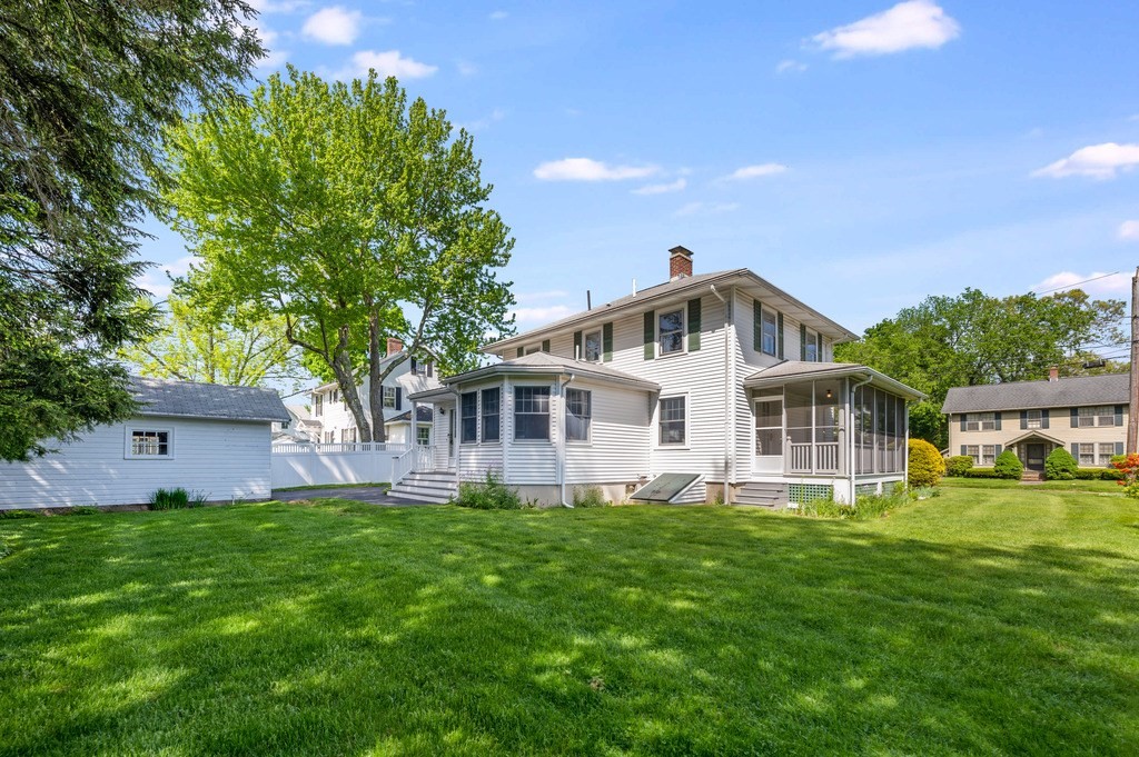 23 Pinewood Road Needham, MA 02492 - Photo 26 of 31 a front view of a house with a garden and trees