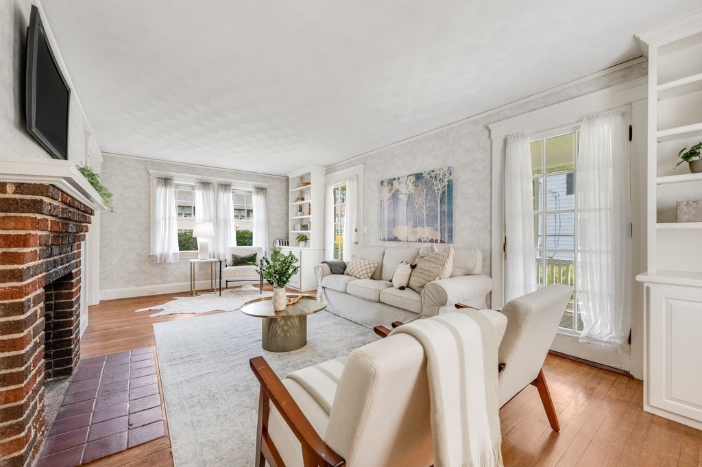 23 Pinewood Road Needham, MA 02492 - Photo 7 of 31 a living room with furniture a fireplace and a flat screen tv