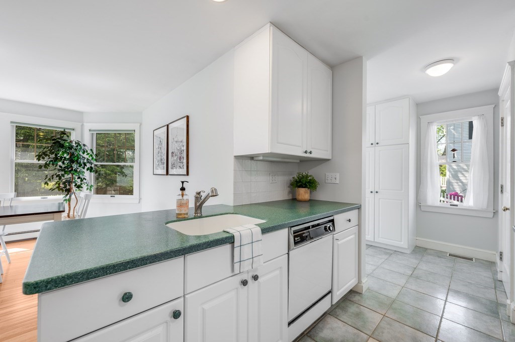 23 Pinewood Road Needham, MA 02492 - Photo 10 of 31 a kitchen with granite countertop a sink and white cabinets