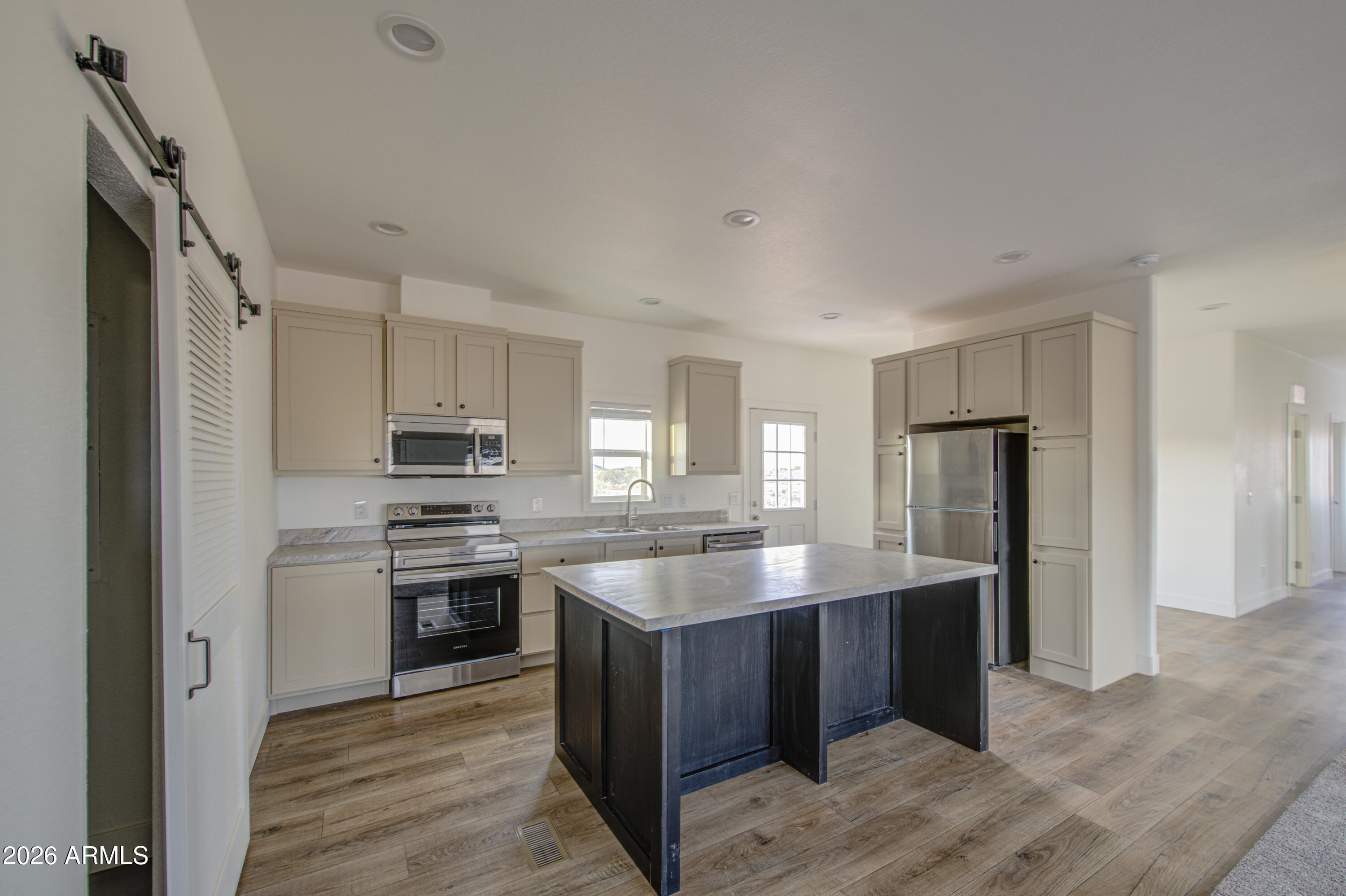 39112 West Maldonado Road Tonopah, AZ 85354 - Photo 11 of 34 a kitchen with stainless steel appliances granite countertop a sink stove and refrigerator