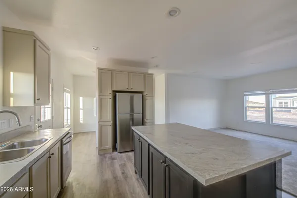 a kitchen with a stove a refrigerator and a sink