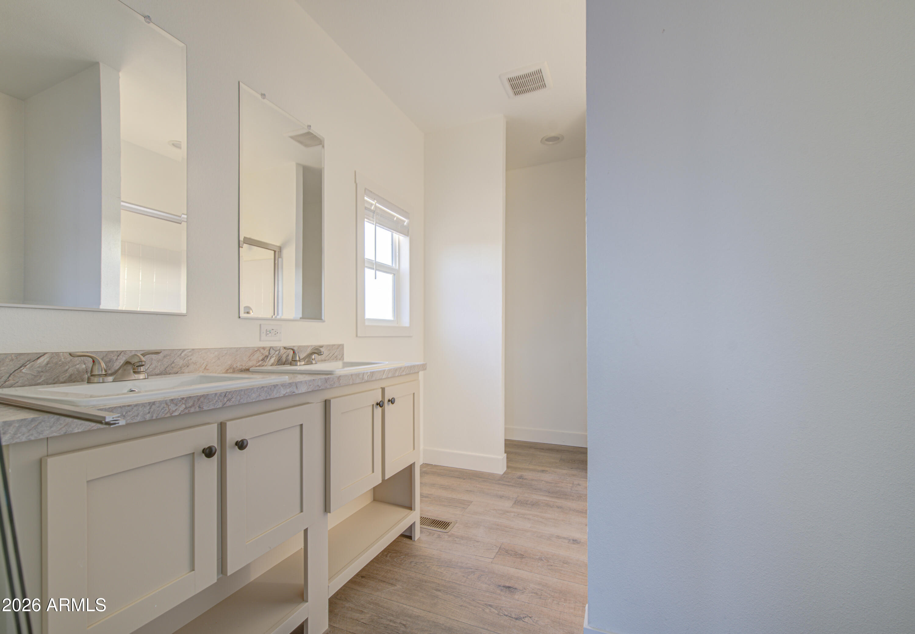 39112 West Maldonado Road Tonopah, AZ 85354 - Photo 19 of 34 a bathroom with a granite countertop sink and a mirror