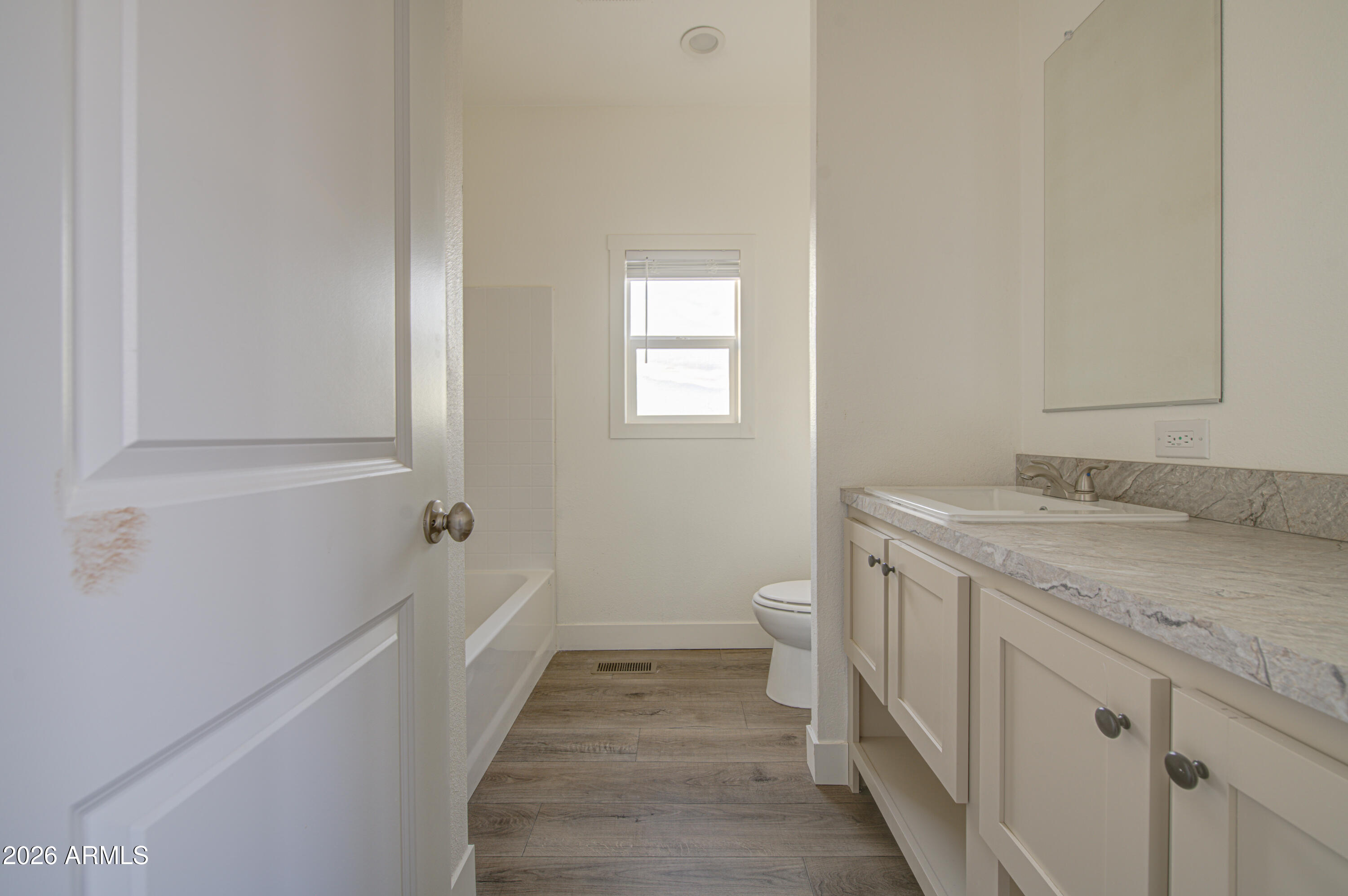 39112 West Maldonado Road Tonopah, AZ 85354 - Photo 28 of 34 a bathroom with a sink and mirror with toilet