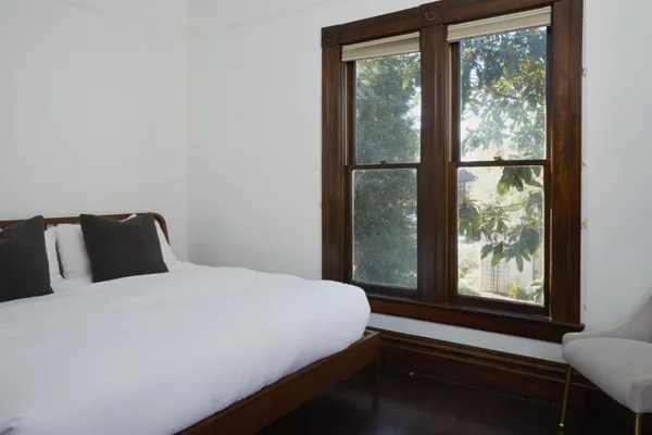 a bedroom with a bed and a window