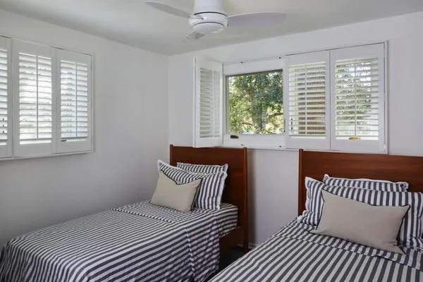 a bedroom with a bed and a window