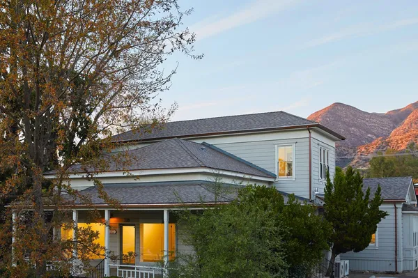 a front view of house with a garden