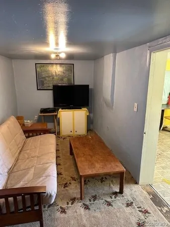 a view of lobby with a chair and frames on wall