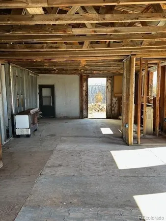 a view of a room with wooden walls and windows