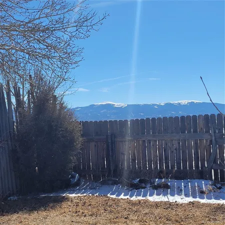 a view of a backyard with wooden fence