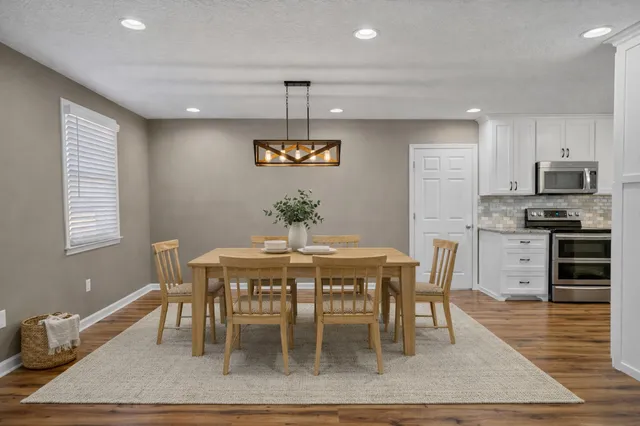 an empty room with window and ceiling fan