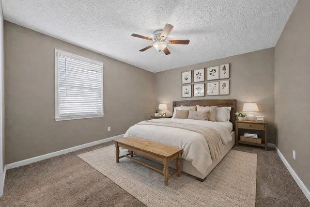 a bedroom with a bed and a chair