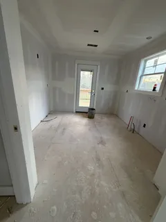 an empty room with windows and closet