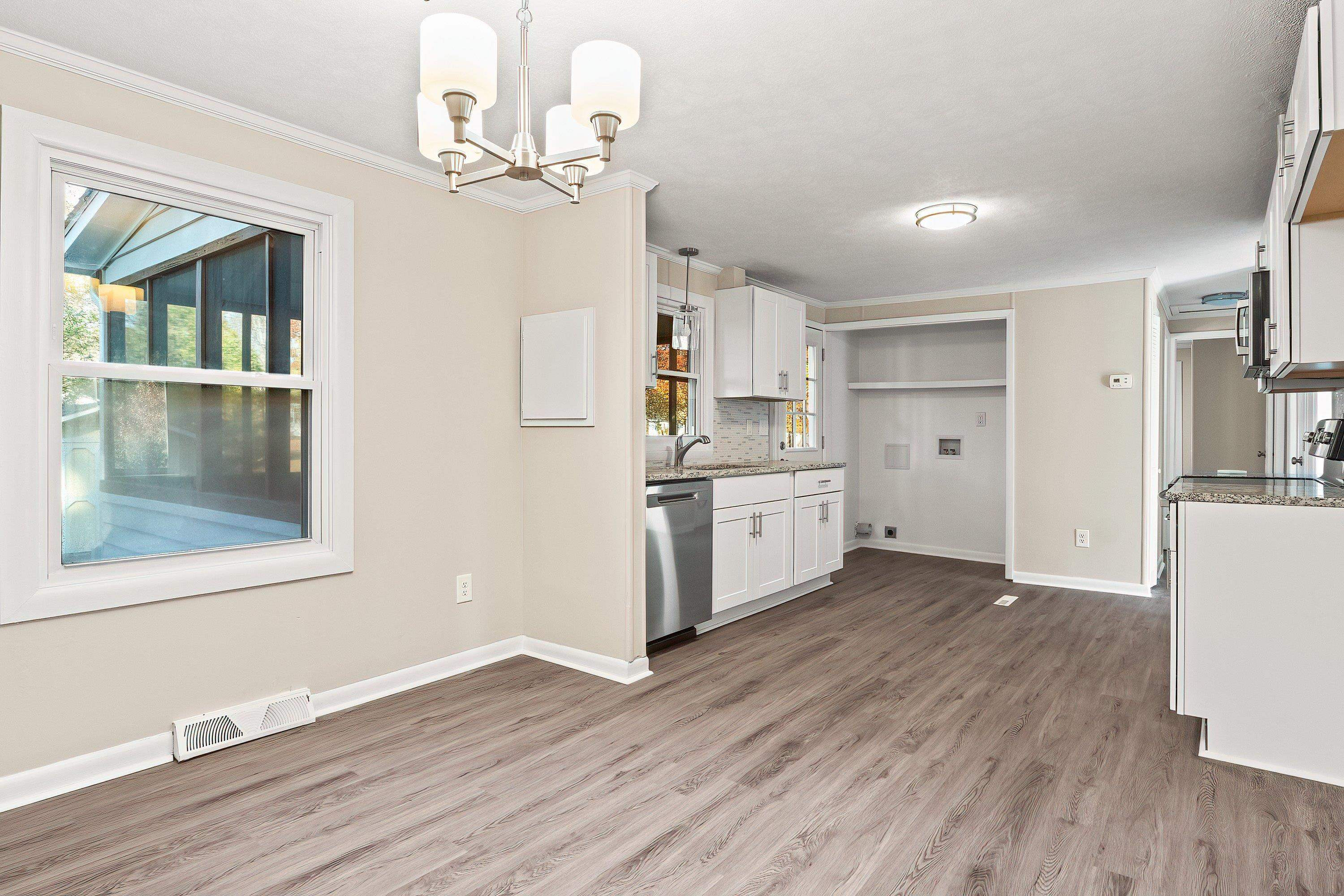 1313 Ewing Drive Garner, NC 27529 - Photo 13 of 46 a kitchen with stainless steel appliances a white stove top oven cabinets a refrigerator and a view of living room