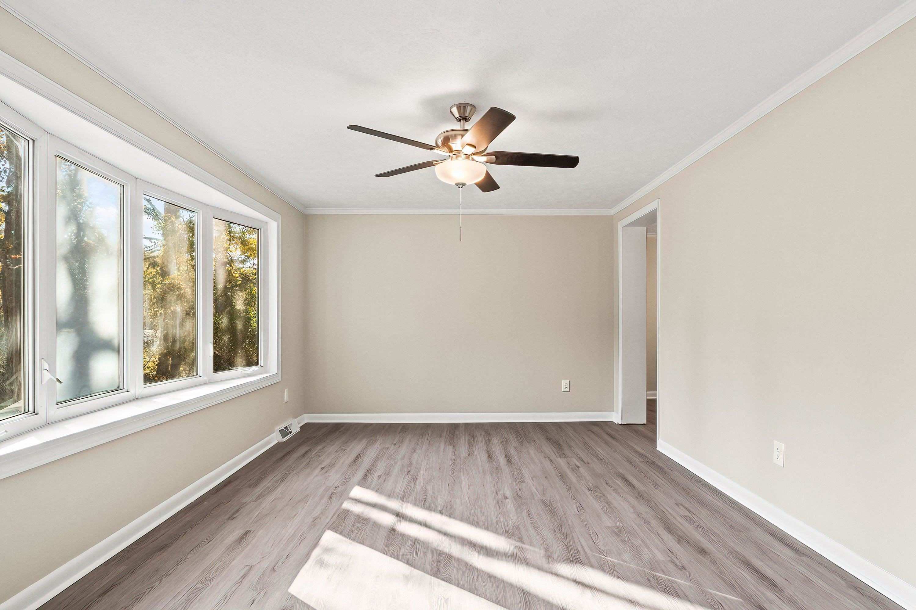 1313 Ewing Drive Garner, NC 27529 - Photo 15 of 46 a view of empty room with wooden floor and fan