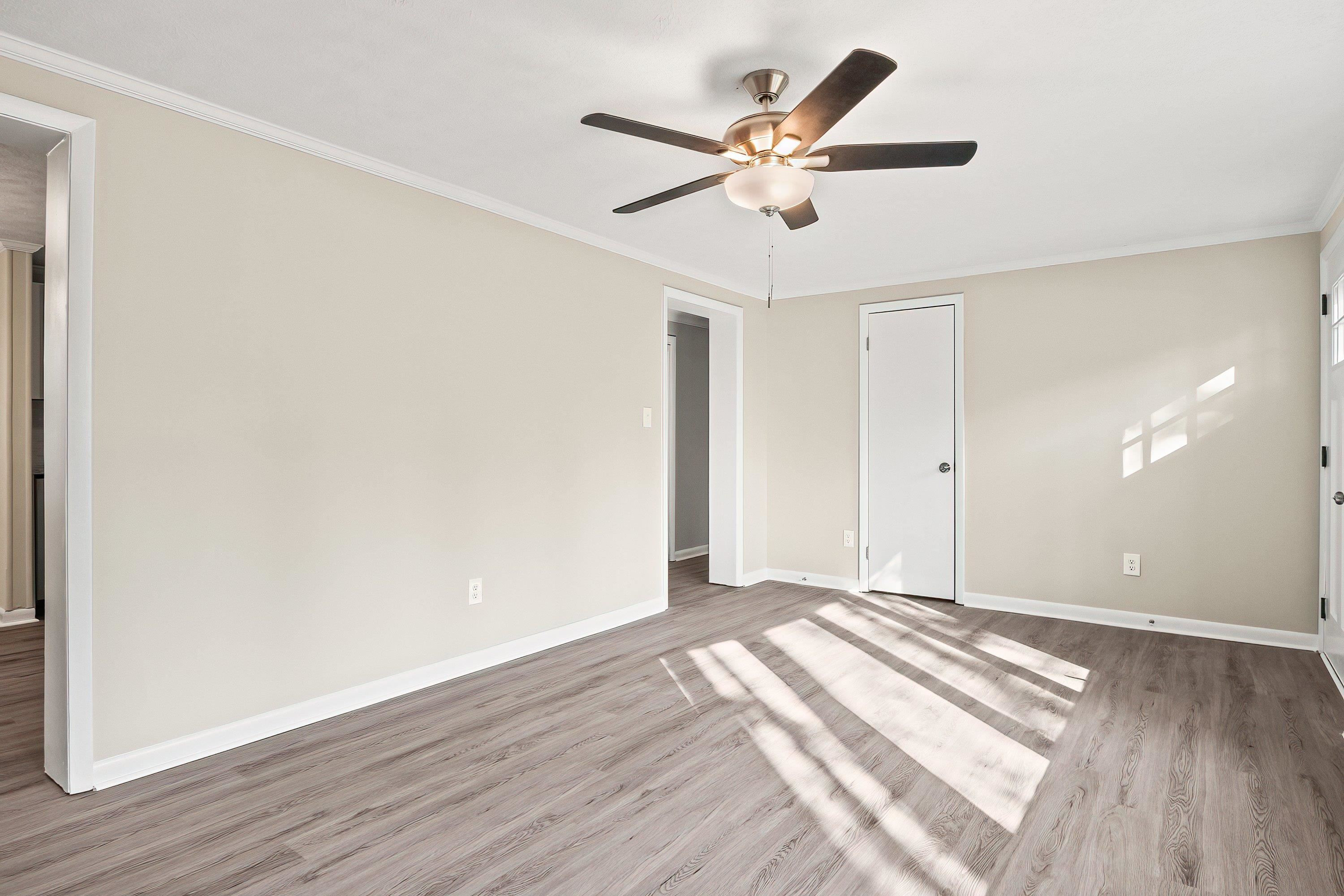 1313 Ewing Drive Garner, NC 27529 - Photo 21 of 46 a view of a big room with wooden floor and a ceiling fan