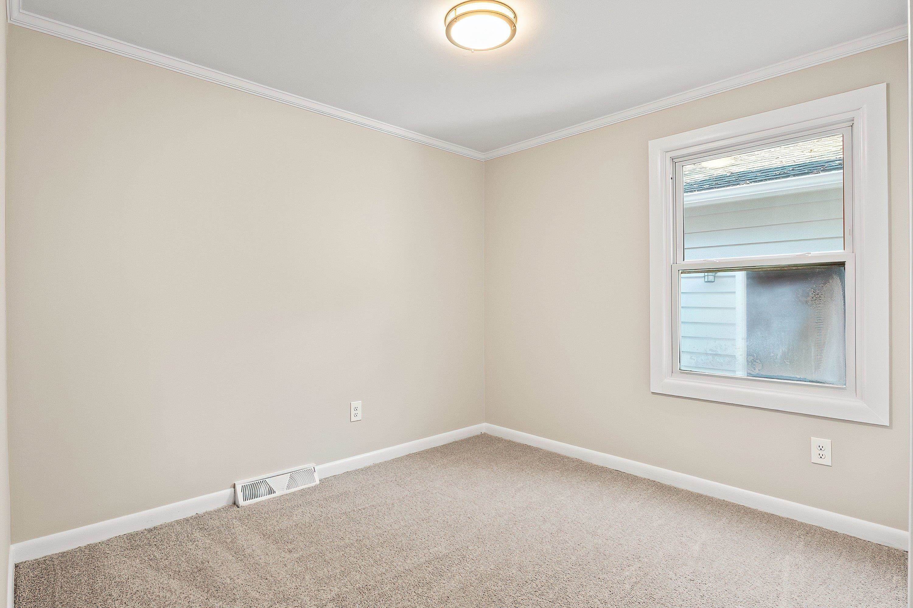 1313 Ewing Drive Garner, NC 27529 - Photo 24 of 46 an empty room with a window