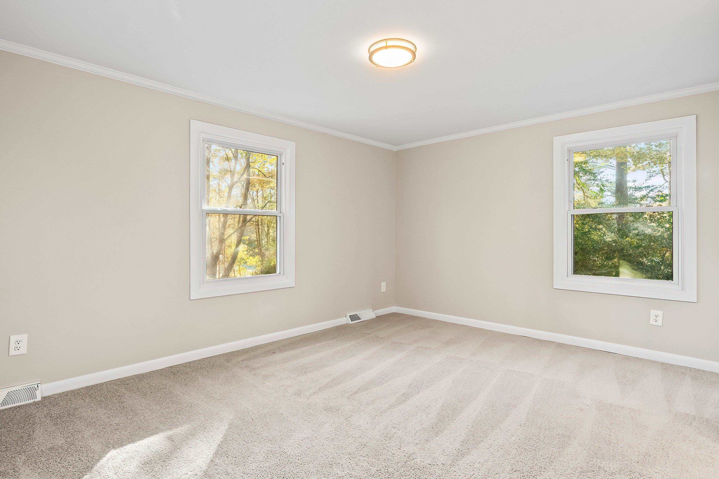 1313 Ewing Drive Garner, NC 27529 - Photo 26 of 46 an empty room with windows