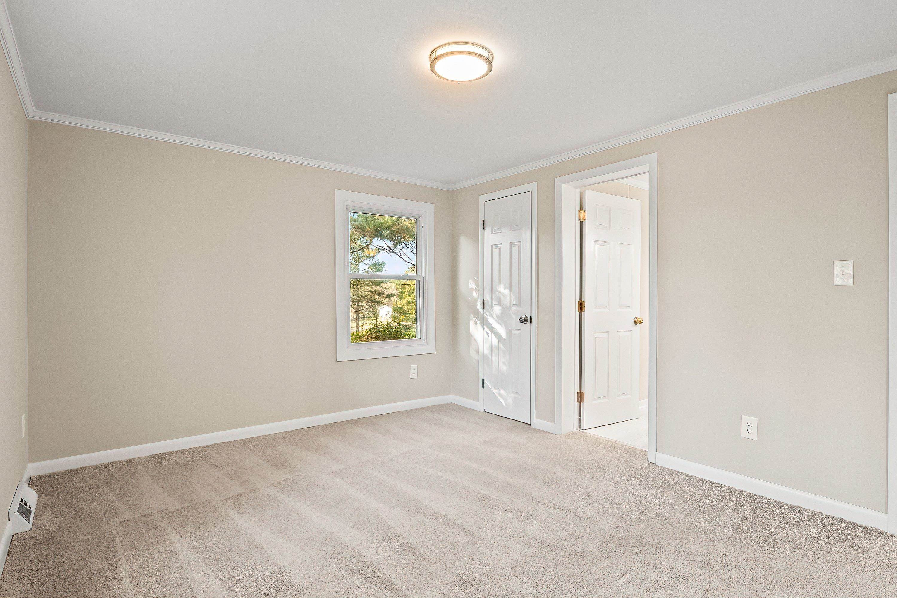 1313 Ewing Drive Garner, NC 27529 - Photo 27 of 46 an empty room with windows and closet