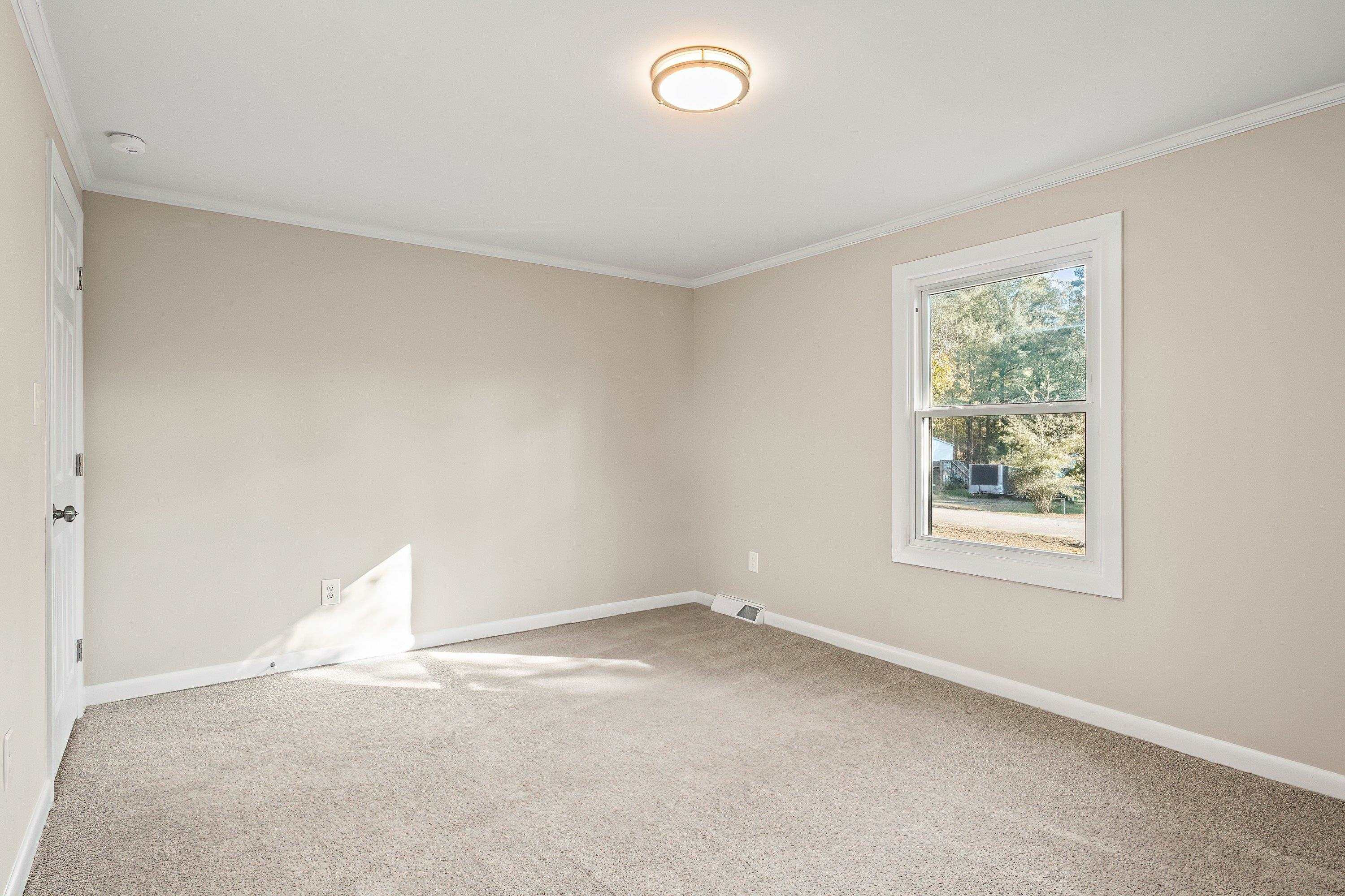 1313 Ewing Drive Garner, NC 27529 - Photo 29 of 46 an empty room with a window