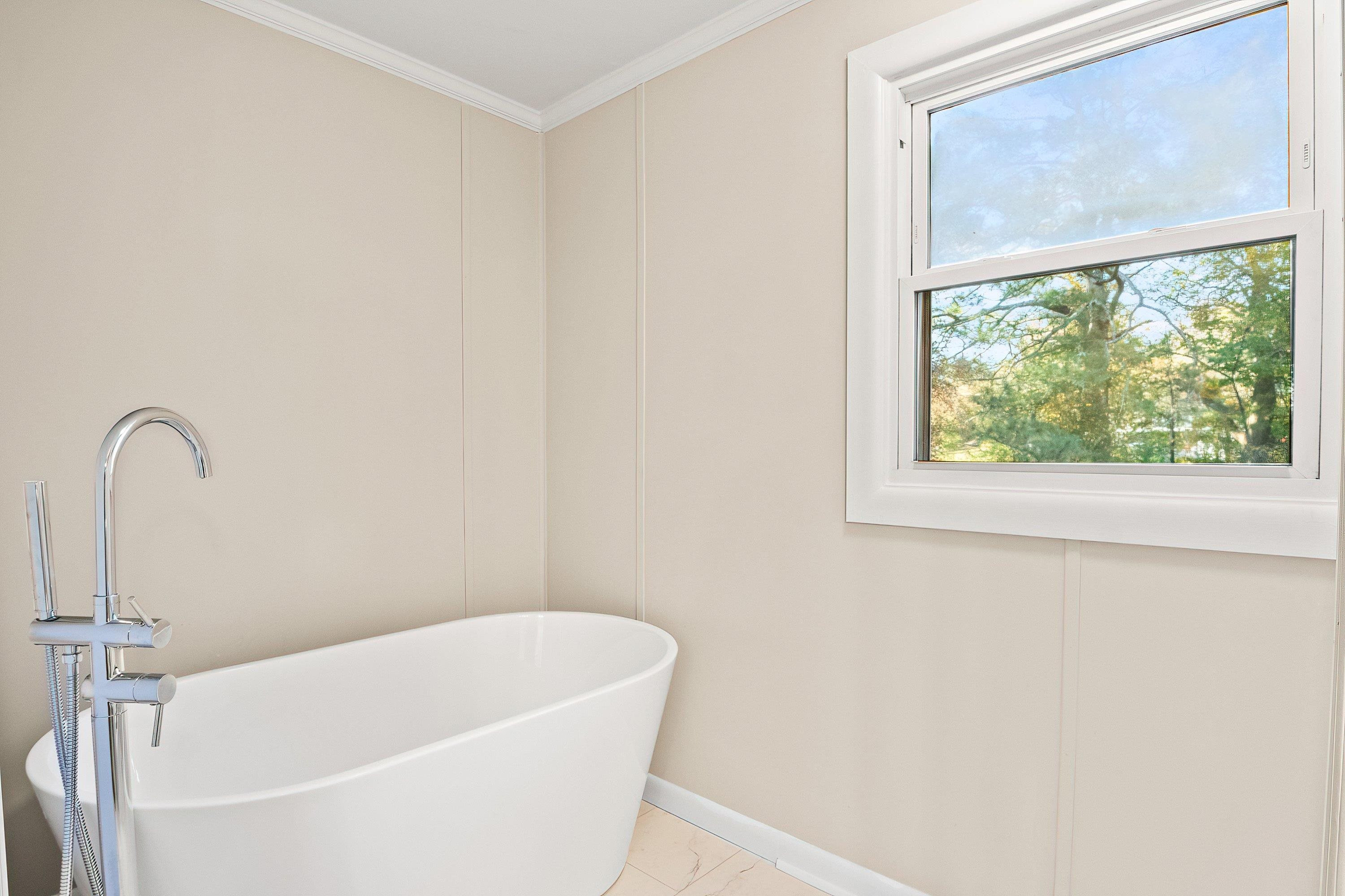 1313 Ewing Drive Garner, NC 27529 - Photo 31 of 46 a white bath tub sitting next to a window
