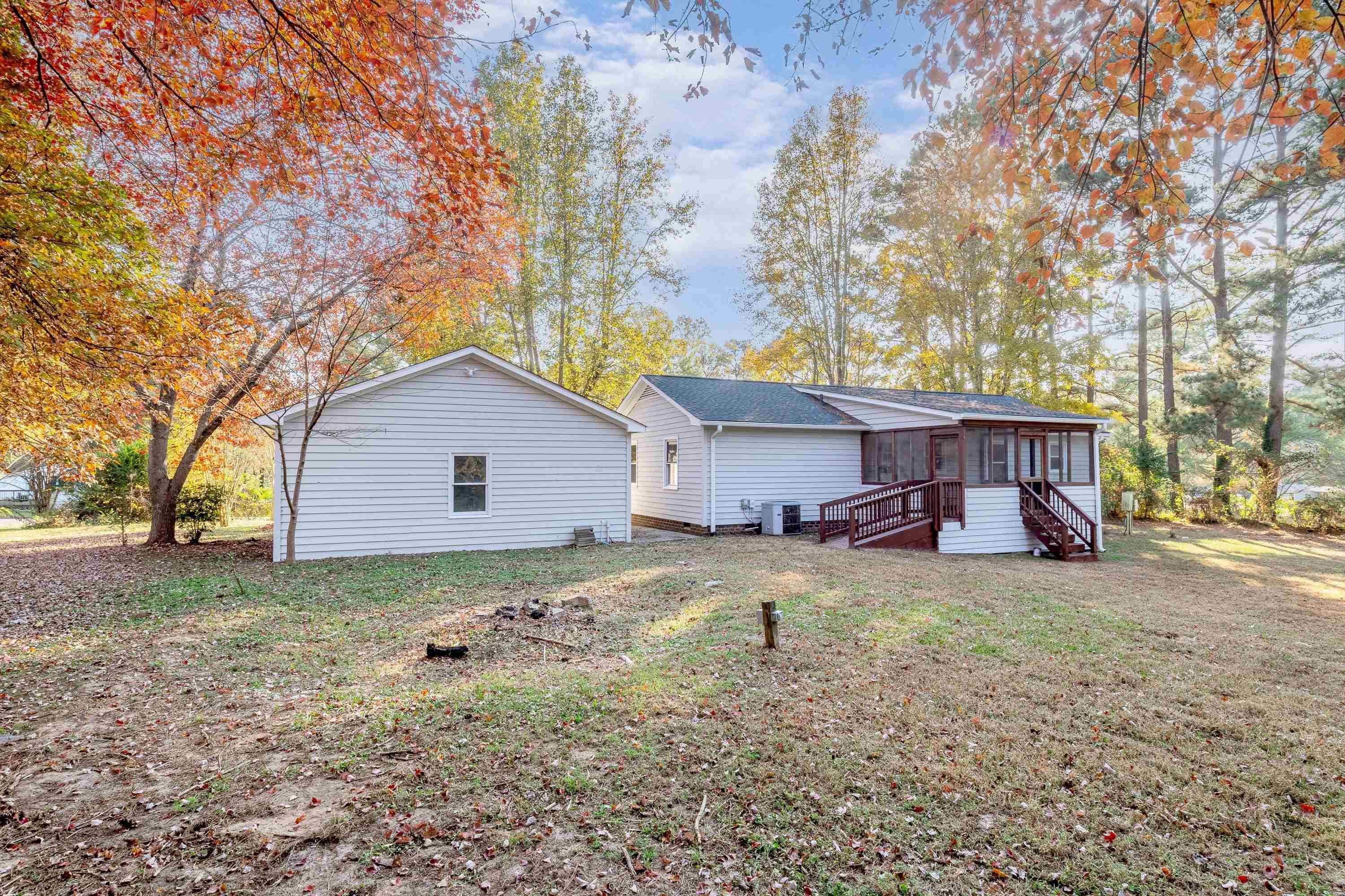 1313 Ewing Drive Garner, NC 27529 - Photo 38 of 46 a view of a house with a yard covered in the forest