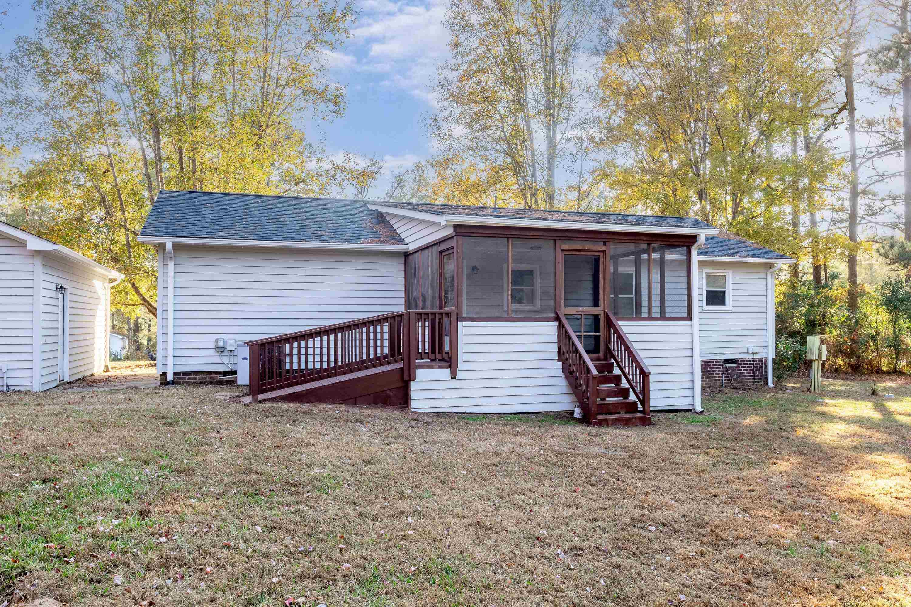 1313 Ewing Drive Garner, NC 27529 - Photo 39 of 46 a view of a house with a yard and wooden fence