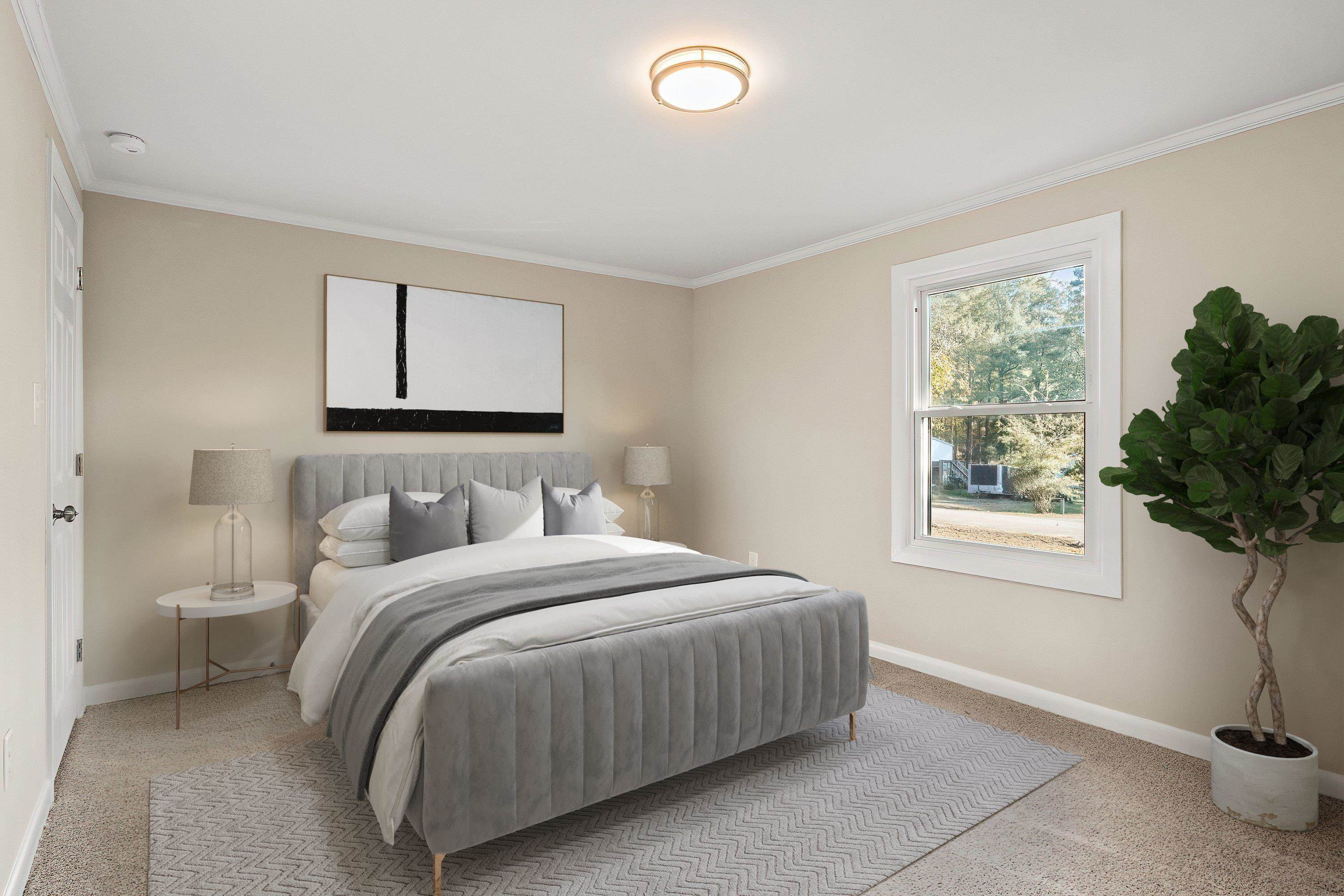 1313 Ewing Drive Garner, NC 27529 - Photo 5 of 46 a bedroom with a bed lamp and window