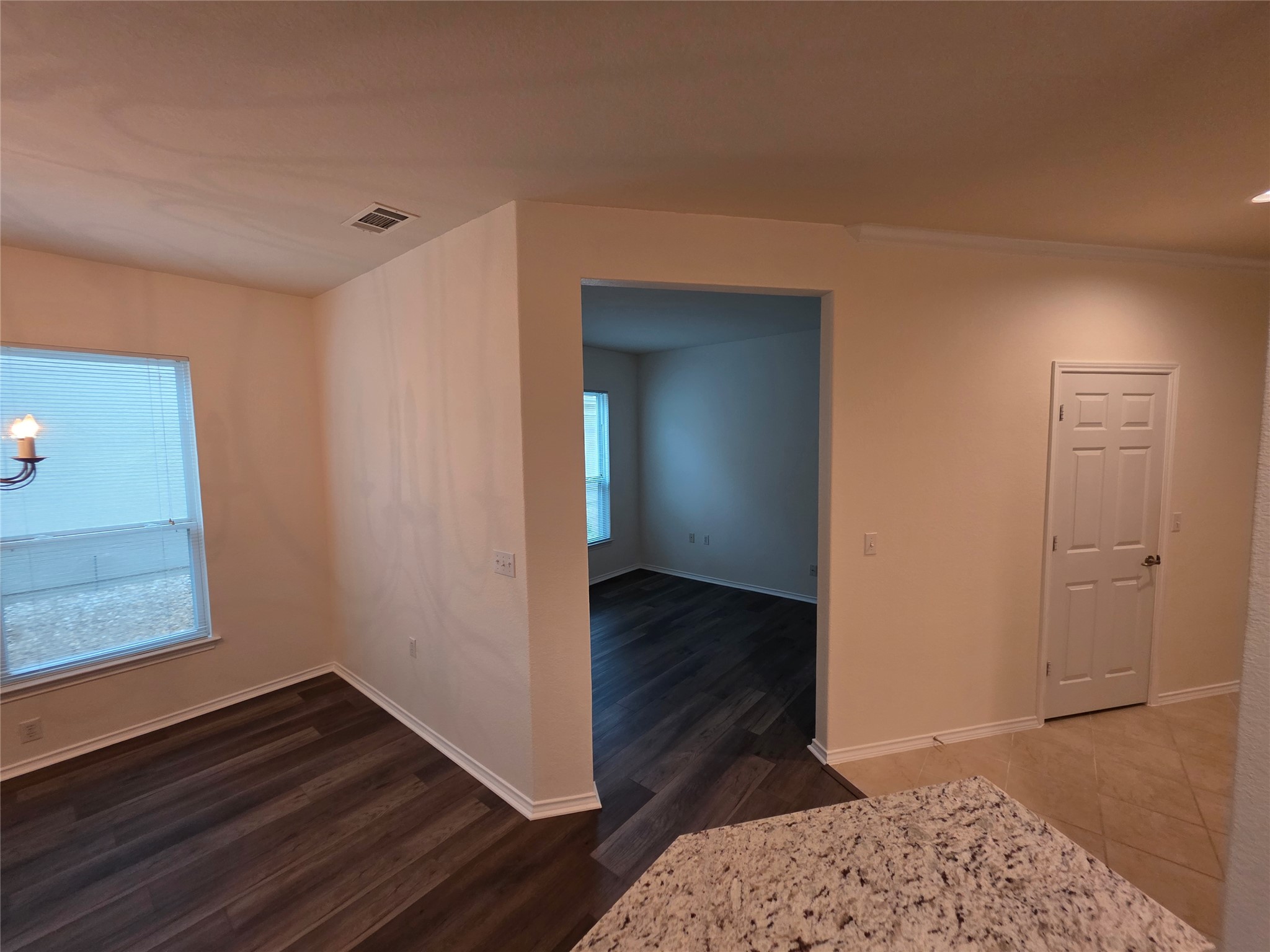 201 Yosemite Road Georgetown, TX 78633 - Photo 10 of 21 Unfurnished dining area with baseboards and dark wood-type flooring