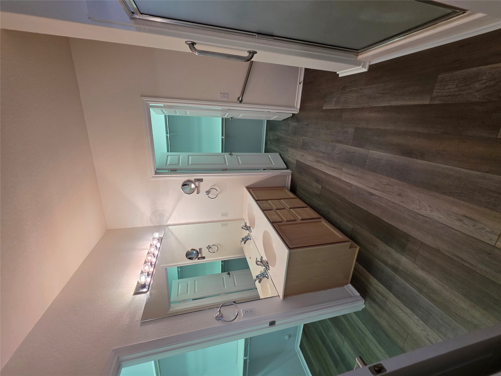 201 Yosemite Road Georgetown, TX 78633 - Photo 14 of 21 Bathroom with a spacious closet, dark wood-style flooring, double vanity, and a shower stall
