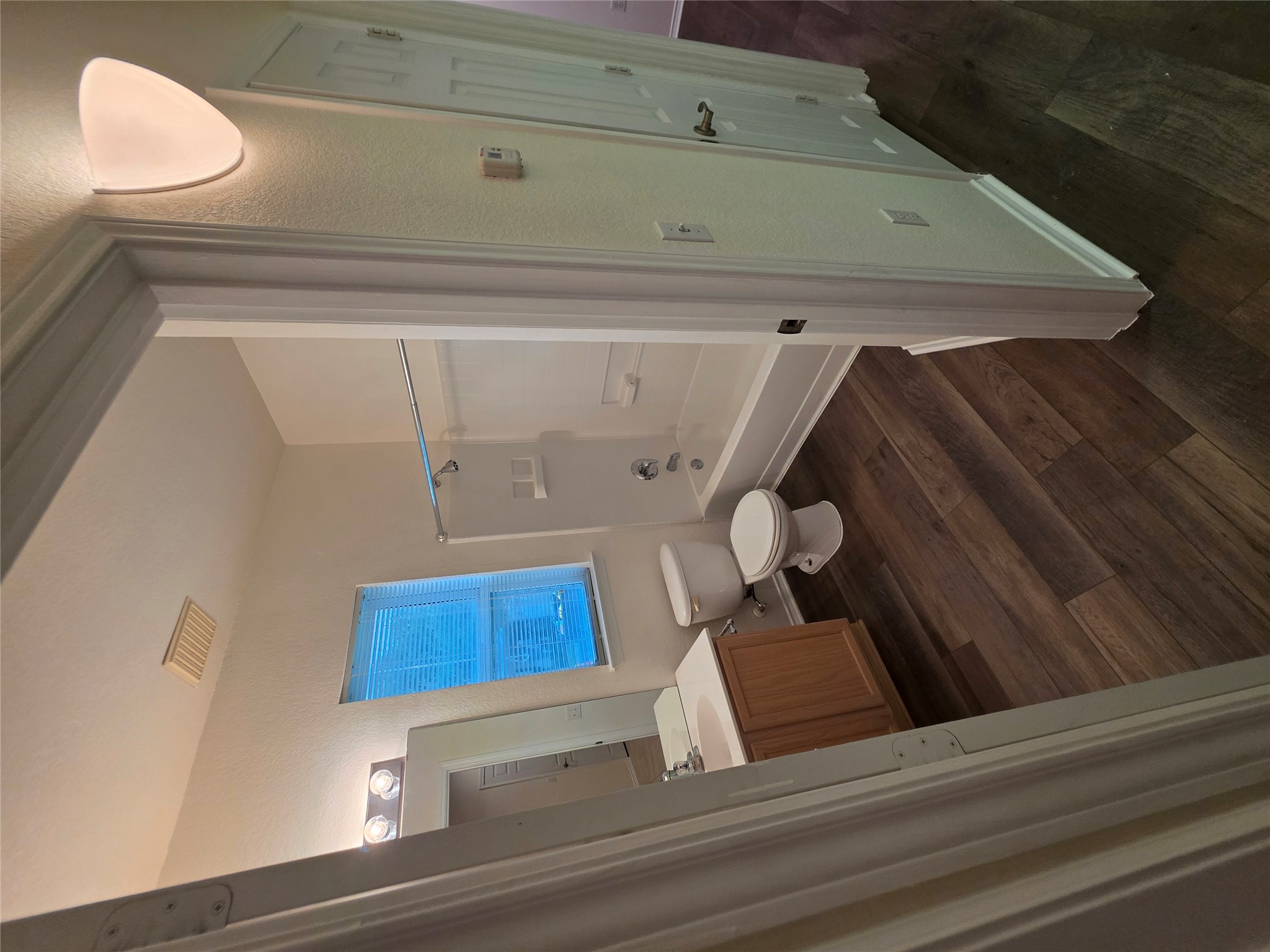 201 Yosemite Road Georgetown, TX 78633 - Photo 19 of 21 Bathroom with shower / tub combination, vanity, dark wood-style floors, and a textured wall