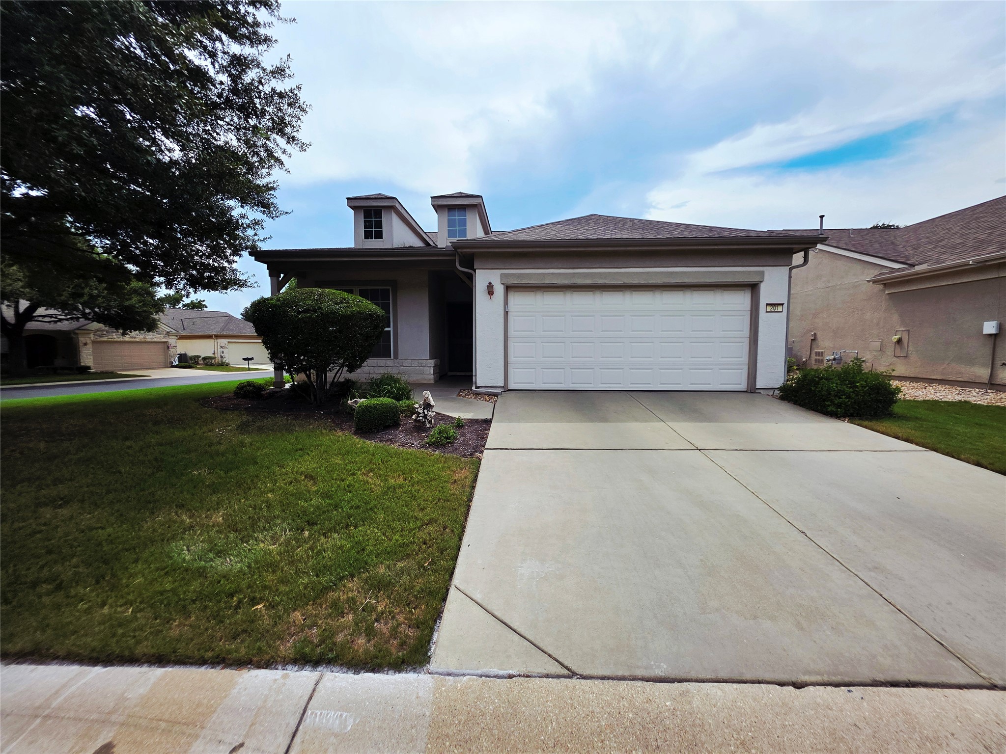 201 Yosemite Road Georgetown, TX 78633 - Photo 2 of 21 View of front of home featuring stucco siding, a garage, concrete driveway, a front yard, and a porch