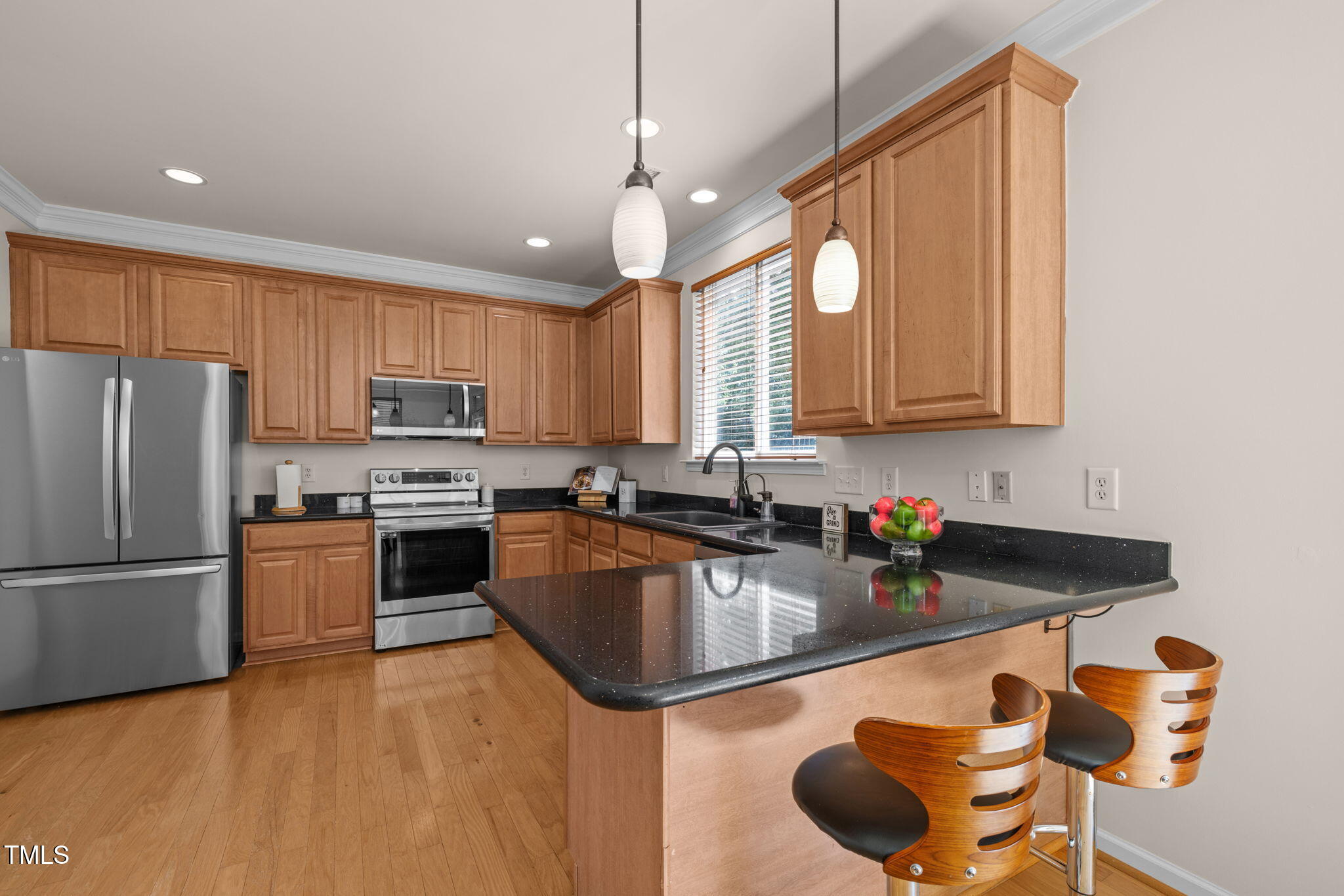 706 Delta Downs Drive Cary, NC 27519 - Photo 13 of 42 a kitchen that has a sink cabinets and stainless steel appliances