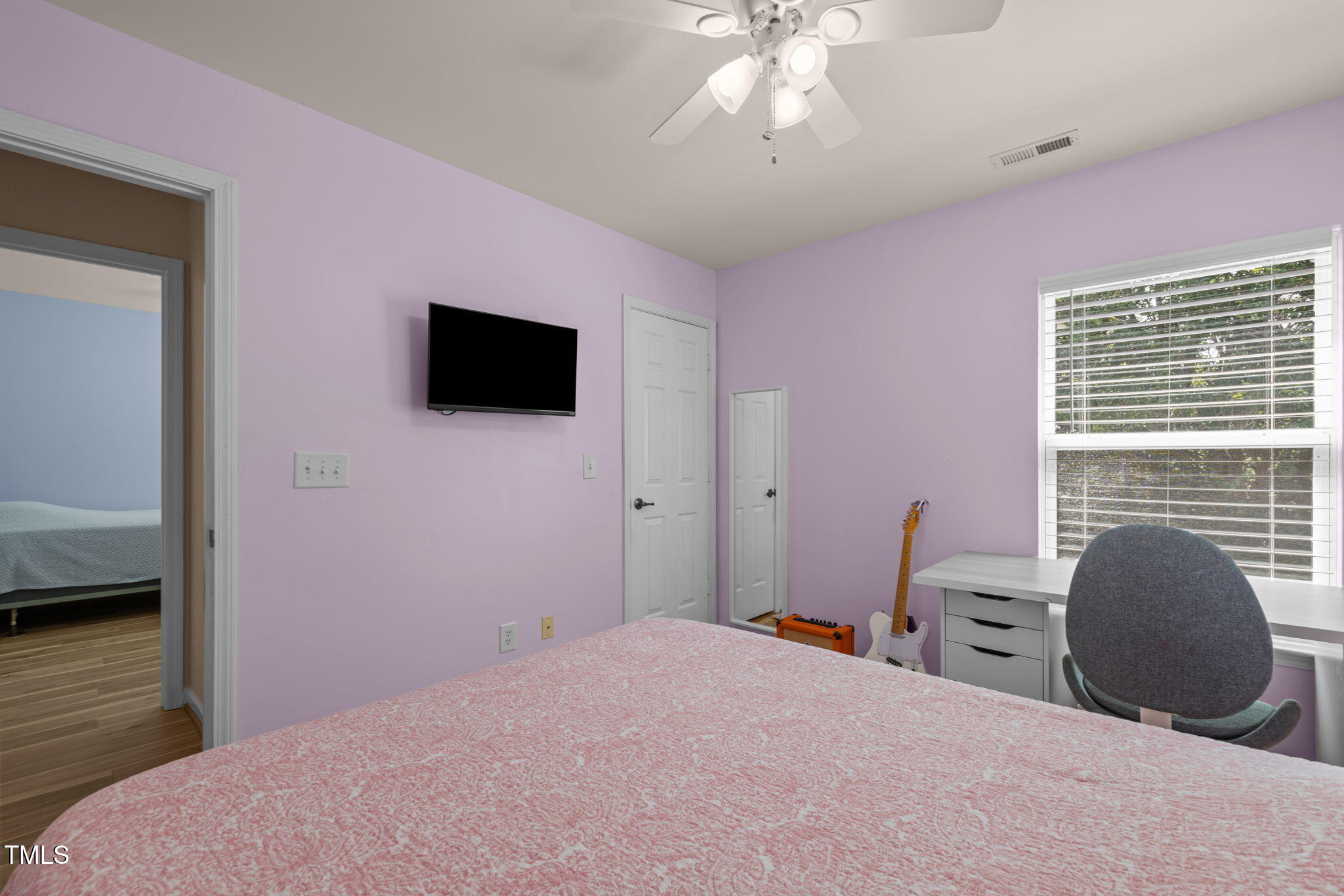 706 Delta Downs Drive Cary, NC 27519 - Photo 32 of 42 a bedroom with a bed and a flat screen tv