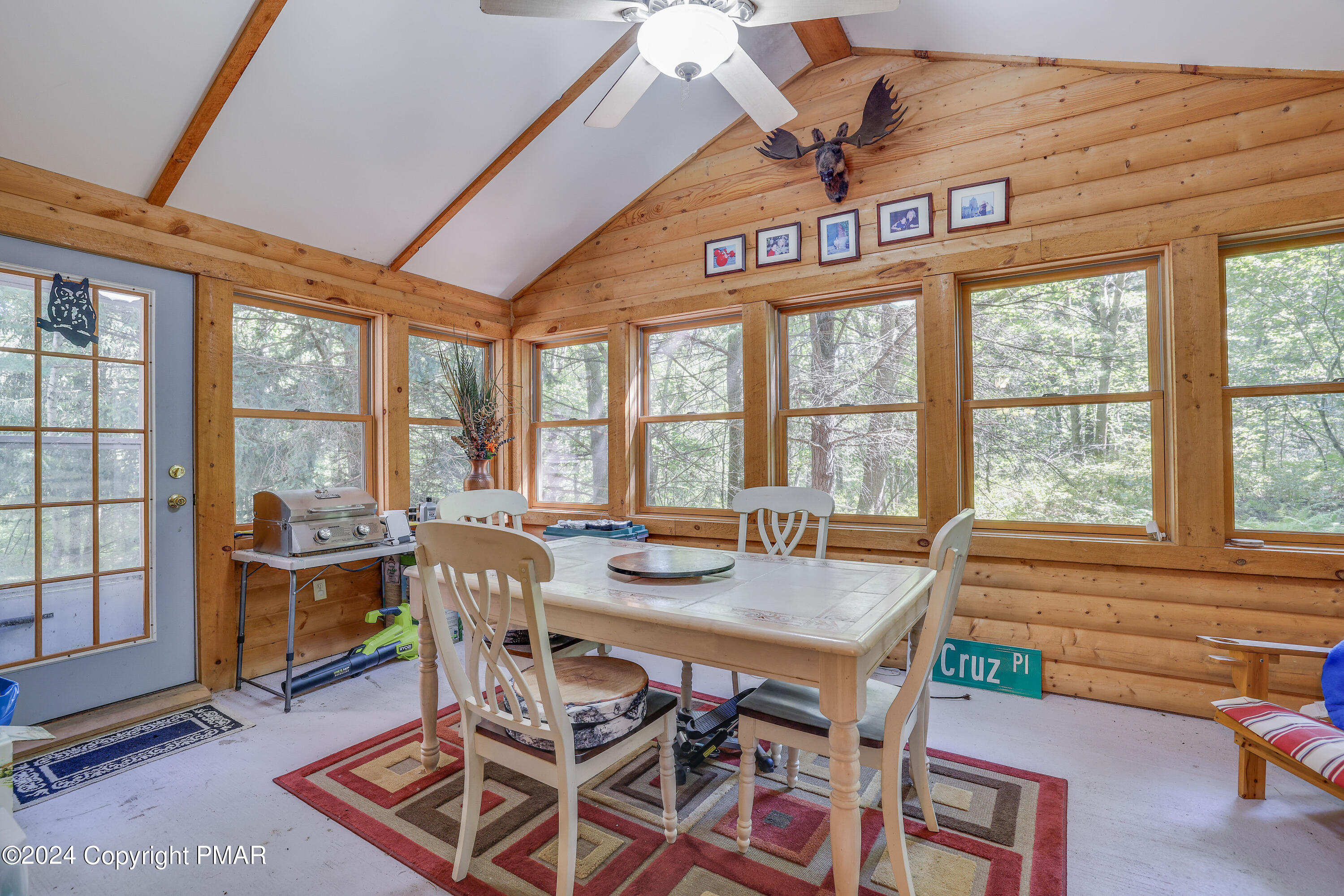 100 Ruffed Grouse Drive Shohola, PA 18458 - Photo 11 of 34 a view of a dining room with furniture large windows and a chandelier