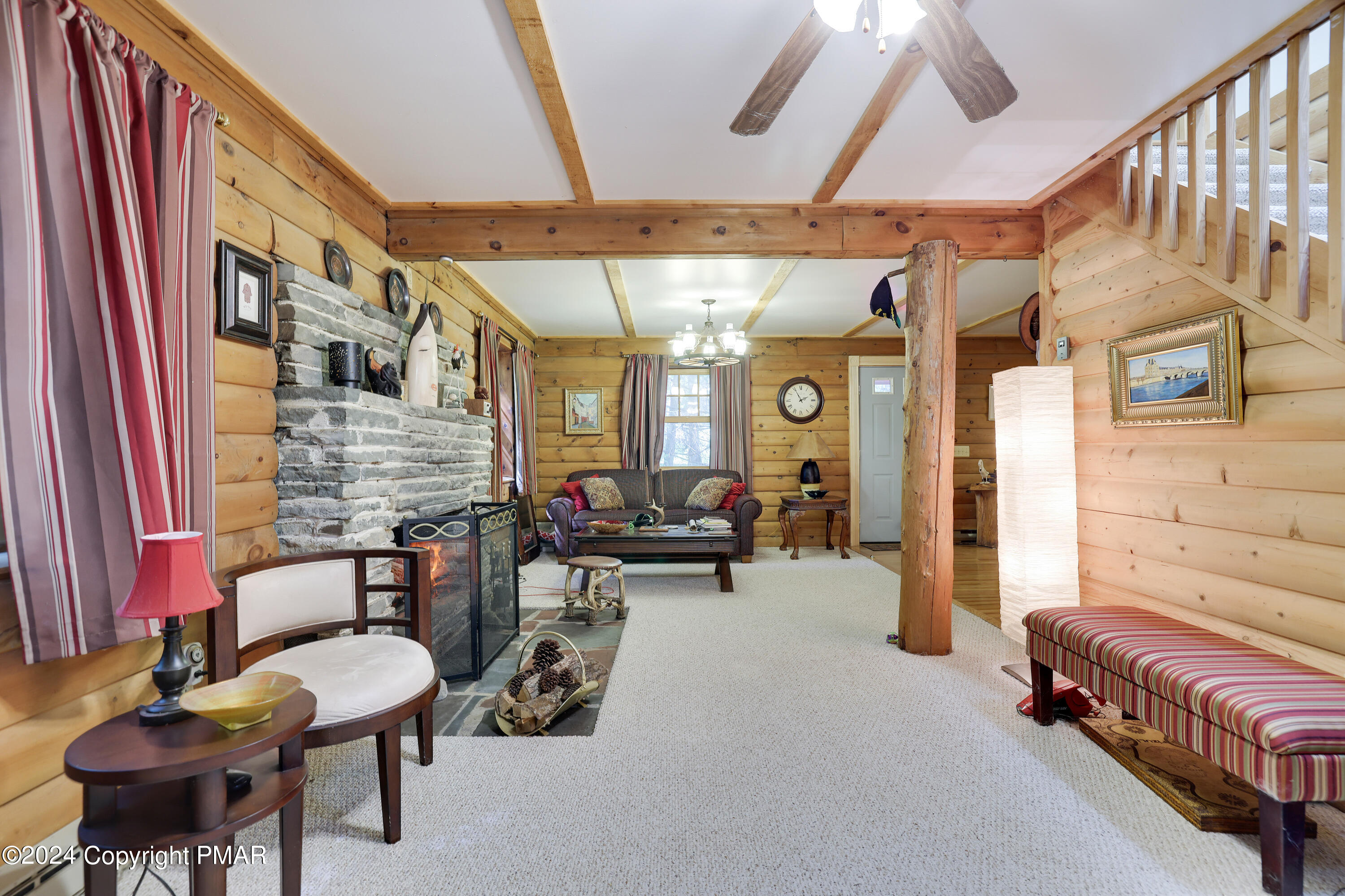 100 Ruffed Grouse Drive Shohola, PA 18458 - Photo 13 of 34 a living room with furniture and a chandelier
