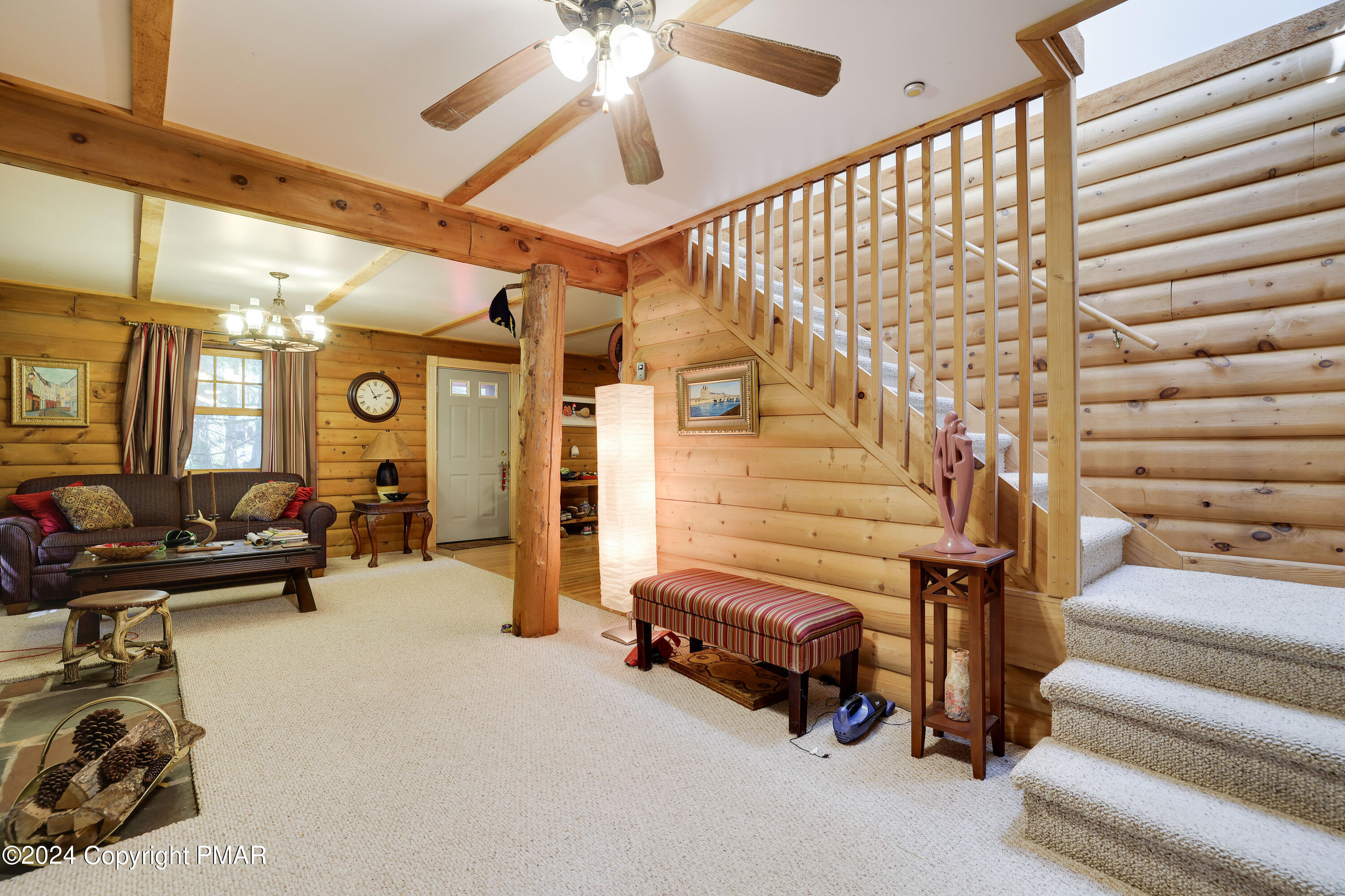 100 Ruffed Grouse Drive Shohola, PA 18458 - Photo 14 of 34 a living room with furniture and a chandelier