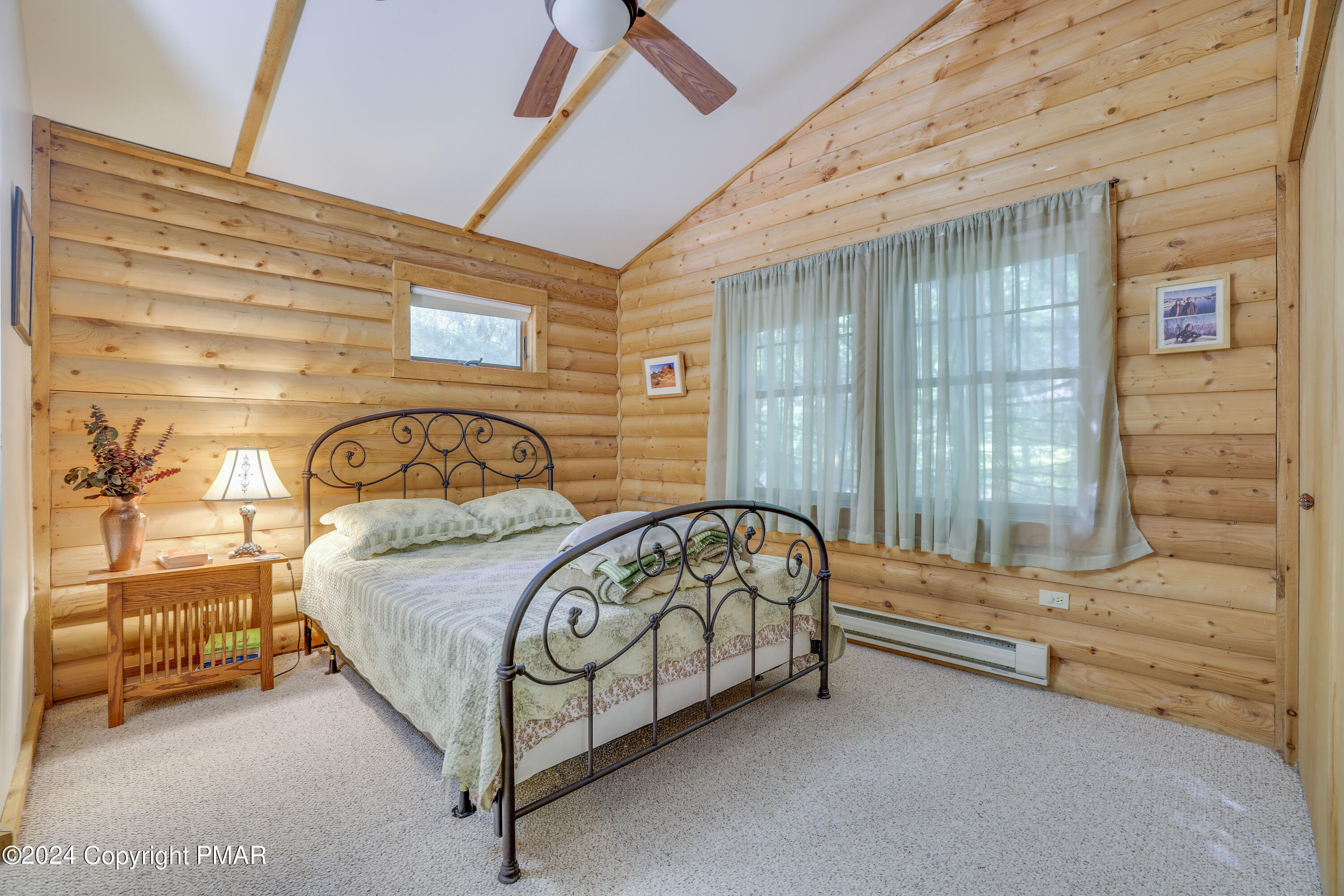 100 Ruffed Grouse Drive Shohola, PA 18458 - Photo 20 of 34 a bedroom with a bed and a window