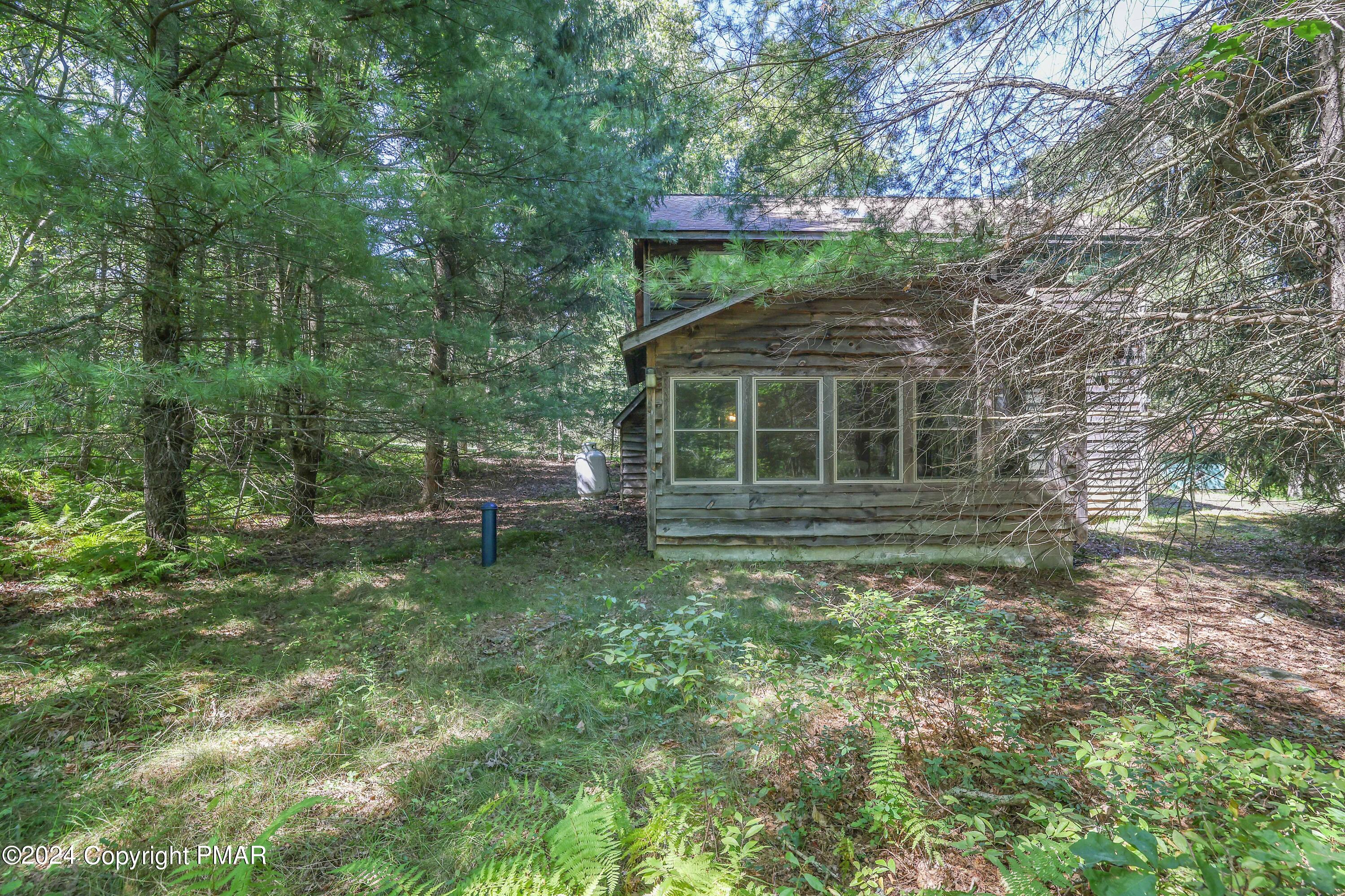 100 Ruffed Grouse Drive Shohola, PA 18458 - Photo 32 of 34 a backyard of a house with lots of green space