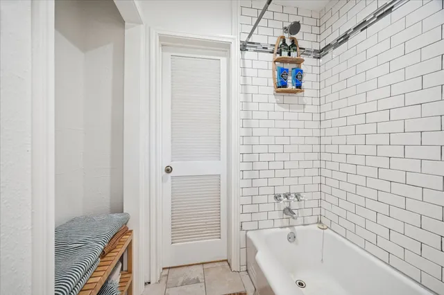 a bathroom with a bathtub and shower